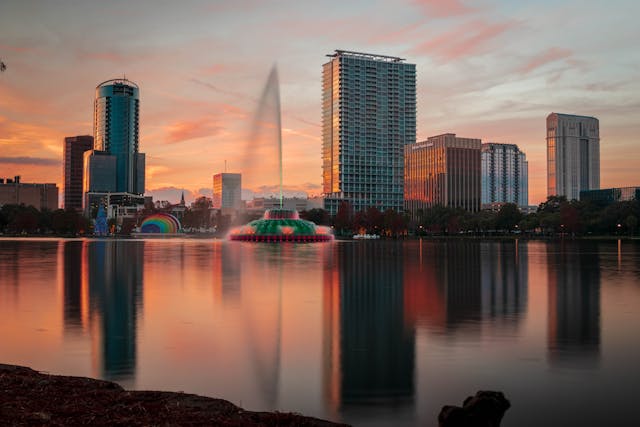 Atardecer en el lago Eola, centro de Orlando en Navidad | Paraviajarporelmundo.com Atardecer en el centro de Orlando con vista al lago Eola y edificios iluminados.