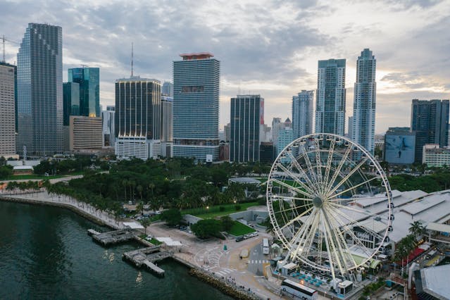 Vista aérea de Downtown Miami con la rueda de la fortuna Skyviews Miami frente a la bahía.