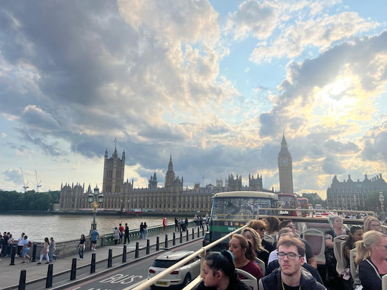 Atardecer en Londres desde el autobús turístico. Turistas en un autobús turístico cruzando Westminster Bridge, con vista al Parlamento y el Big Ben al atardecer en Londres.