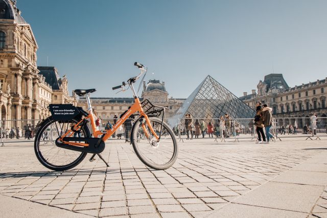 Bicicleta frente al Museo del Louvre en París, una de las ciudades más atractivas para recorrer en bicicleta.