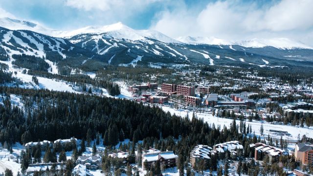 Vista panorámica de Breckenridge, Colorado, con montañas nevadas, pistas de esquí y el pueblo cubierto de nieve durante el invierno.