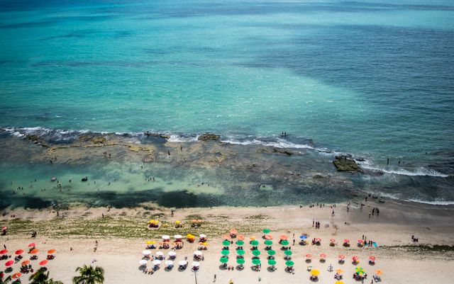 Playas de Brasil en enero y febrero de 2027 Vista aérea de una playa de Brasil con piscinas naturales entre arrecifes y turistas