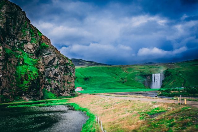 Skógafoss en verano: mejor época para recorrer Islandia Cascada Skógafoss rodeada de campos verdes en el sur de Islandia durante los meses de clima más templado.